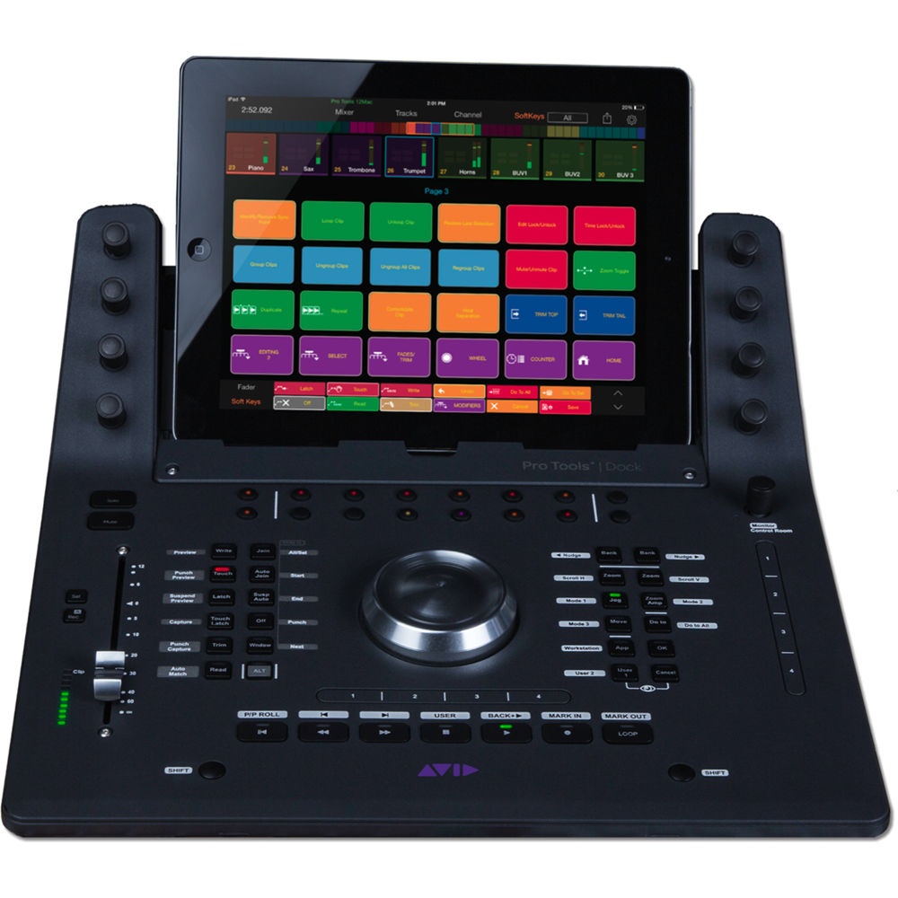 Avid Dock compact touchscreen control surface on mixing desk next to studio monitor — view 3