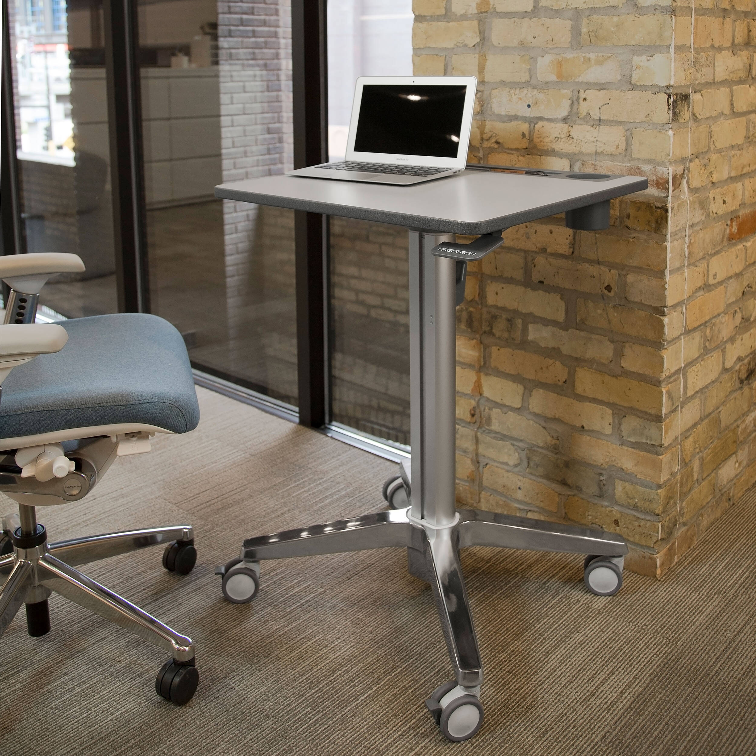 Ergotron LearnFit adjustable standing desk with locking casters and cup holder — view 7