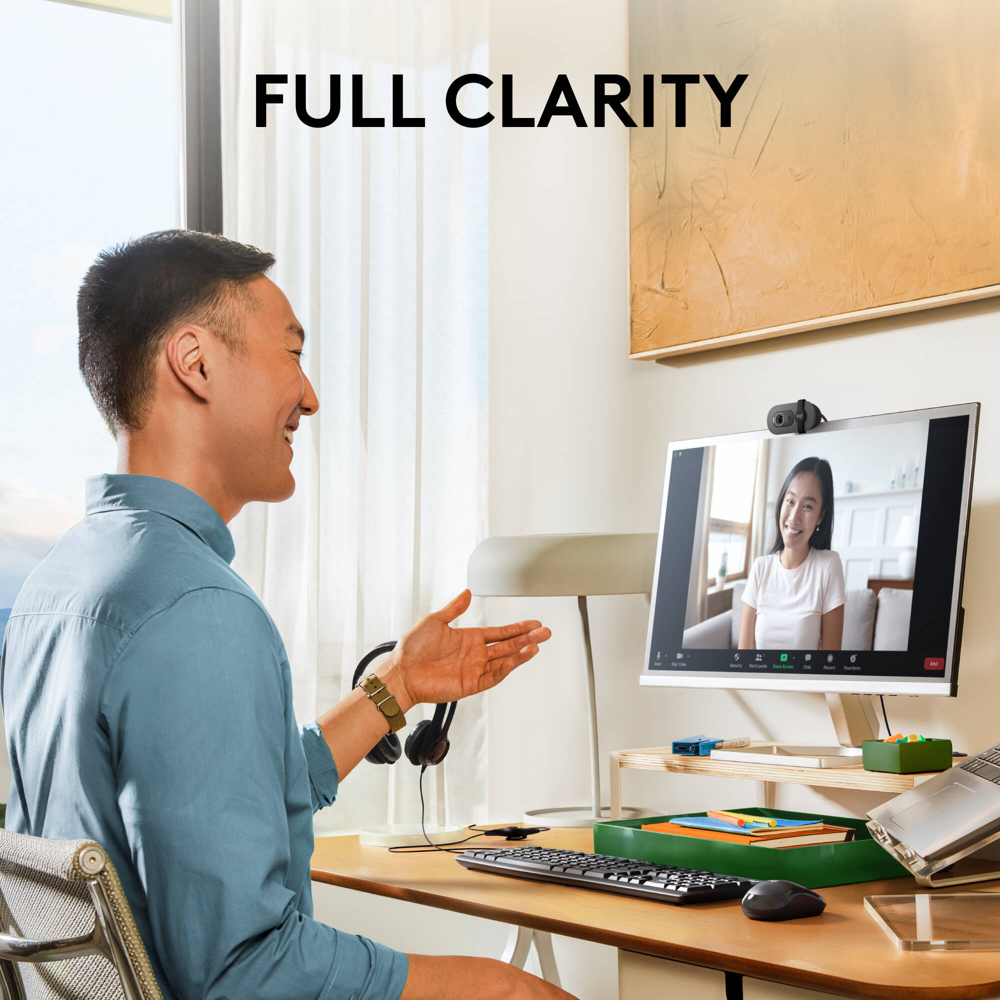 Logitech Brio 100 webcam in graphite with privacy shutter and clip-on mount — view 2